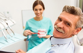 man at a consultation with his denture dentist in Beverly 
