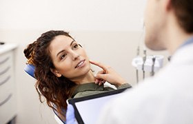A woman speaking to her dentist