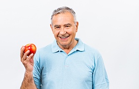 mature man about to eat an apple  