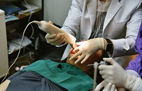 Dentist capturing digital impressions using dental implant technology in Beverly