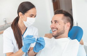 A dentist explaining factors behind the cost of Invisalign