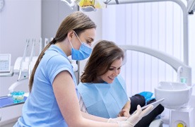 A woman paying the cost of Invisalign
