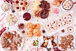 Holiday cookies, candy, and treats displayed on a white table