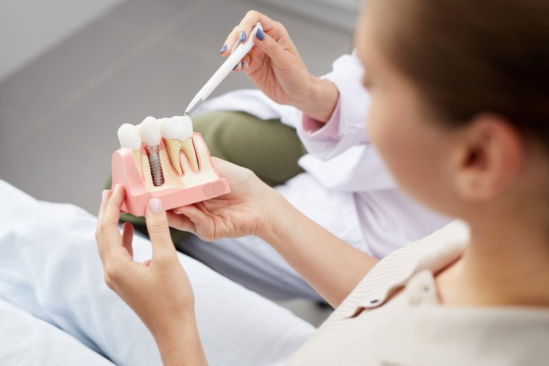 A dentist discussing dental implant success with a patient