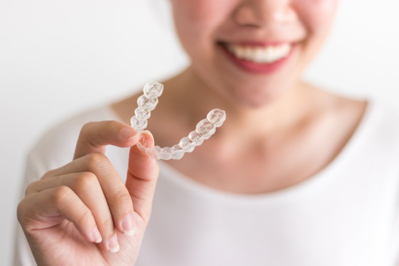 patient holding Invisalign tray