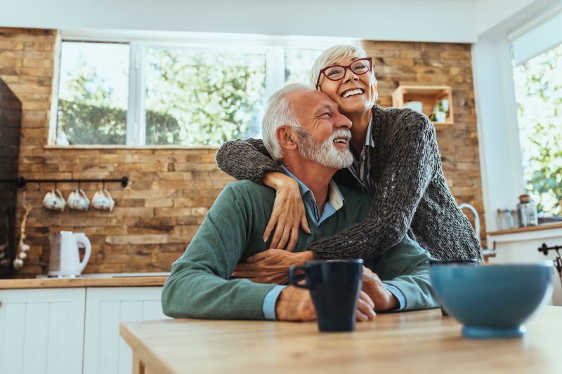 Older couple embracing and wearing a denture