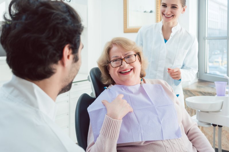 older woman meeting with dentist for dental checkup