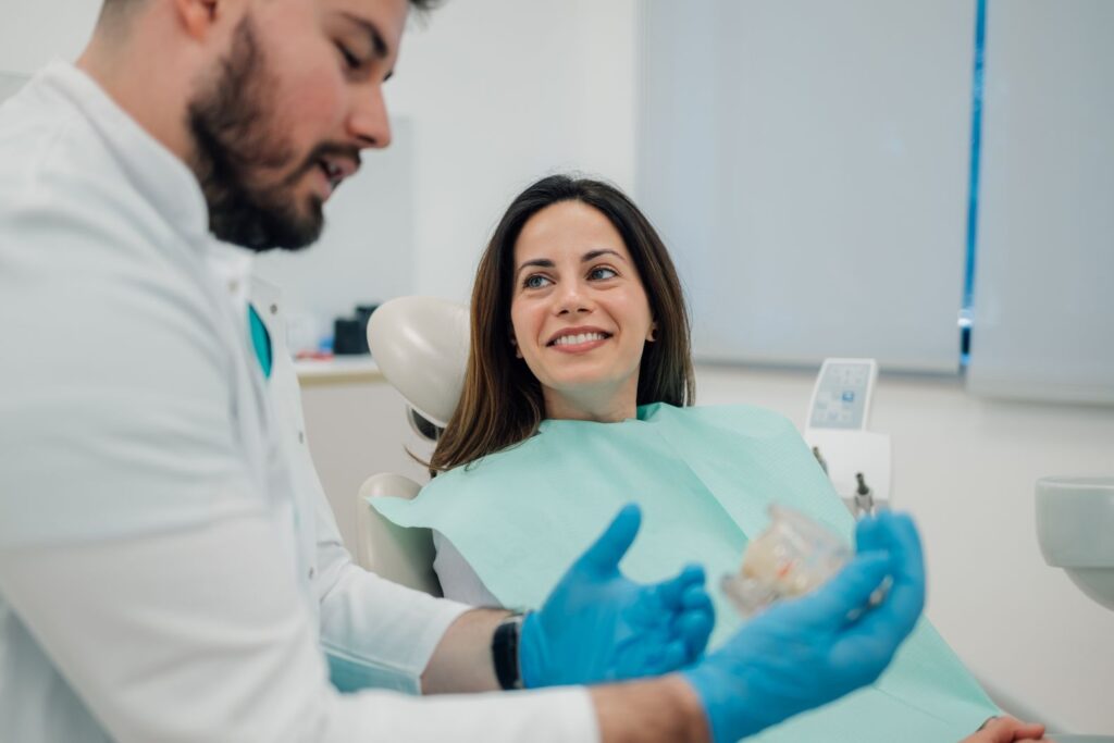 A woman discussing dentures with her dentist